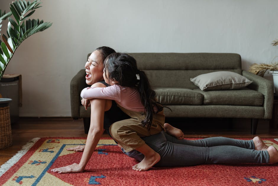 Happy child in a tree pose in a living room, smiling brightly.